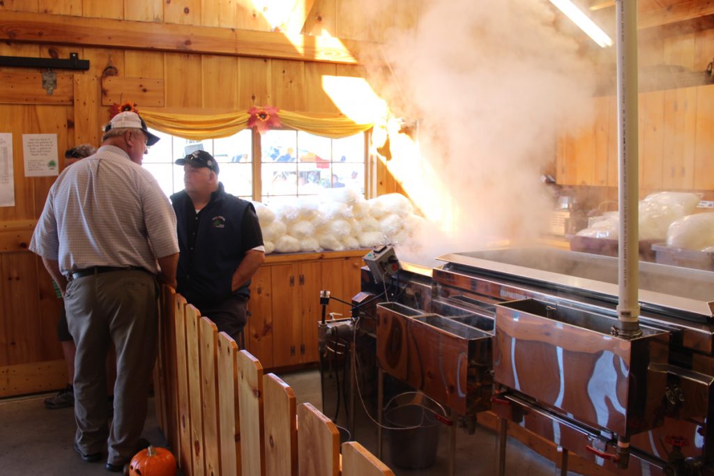 Rodney talks with former Maine agriculture commissioner Seth Bradstreet in the Sugar House at Fryeburg Fair.