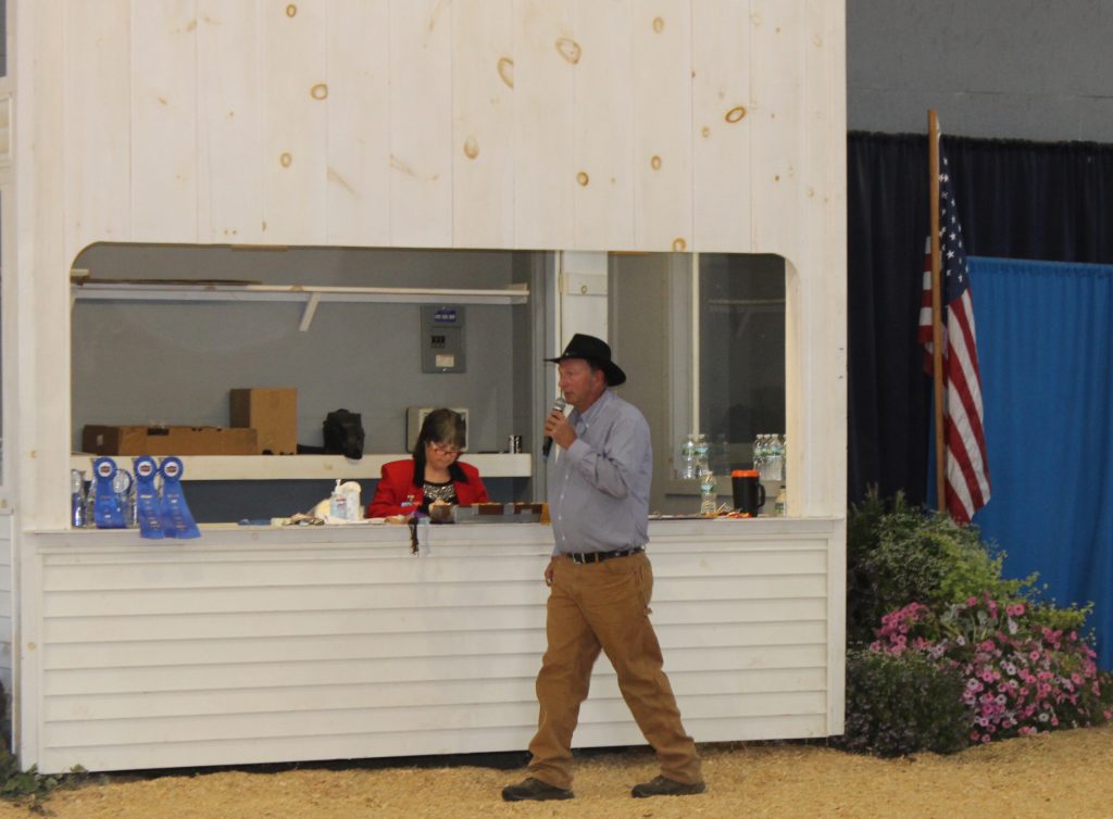 Randy Hall, the beef superintendent at Fryeburg Fair, announces the next cattle class.